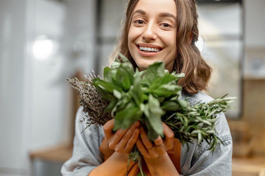 A woman holding a root vegetable.